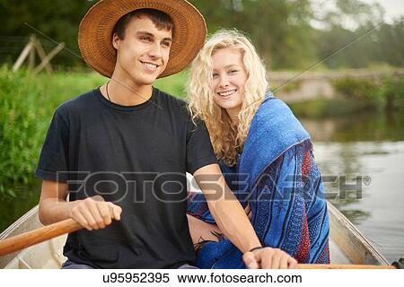 Portrait of young couple in river rowing boat View Large Photo Image Stock Photography - Portrait of young couple in river rowing boat. Fotosearch