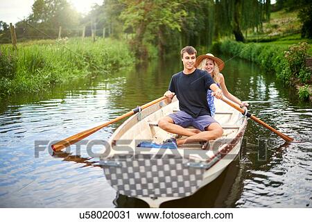 Portrait of young couple rowing on rural river View Large Photo Image Stock Image - Portrait of young couple rowing on rural river. Fotosearch