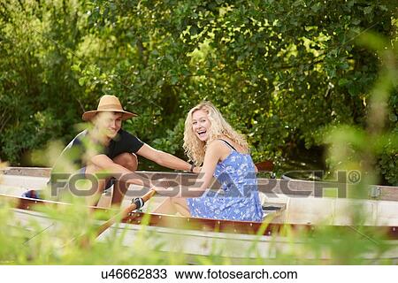 Portrait of young couple rowing river rowing boat View Large Photo Image Stock Image - Portrait of young couple rowing river rowing boat. Fotosearch