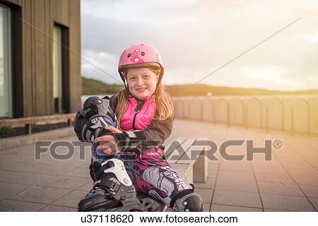 Portrait of young girl wearing rollerblades View Large Photo Image Stock Image - Portrait of young girl wearing rollerblades. Fotosearch