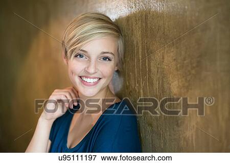 Portrait of young woman leaning against wooden wall View Large Photo Image Stock Photo - Portrait of young woman leaning against wooden wall. Fotosearch