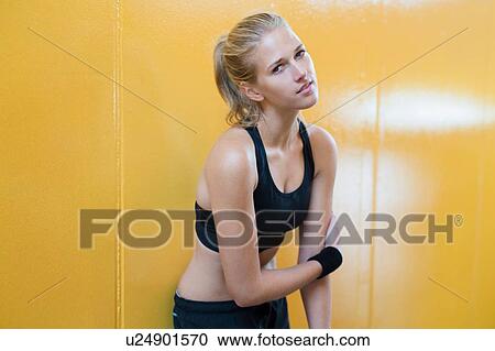 Stock Image - Portrait of young woman wearing sports clothing. Fotosearch