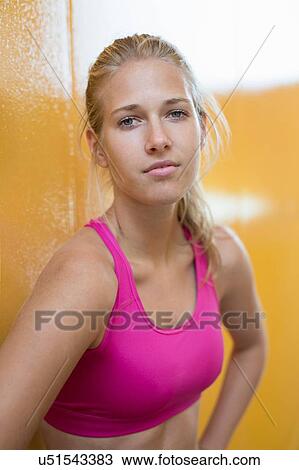 Stock Image - Portrait of young woman wearing sports clothing. Fotosearch