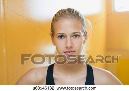 Stock Image - Portrait of young woman wearing sports clothing. Fotosearch