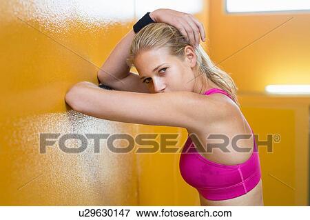 Stock Photo - Portrait of young woman wearing sports clothing. Fotosearch