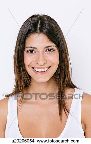 Portrait of young woman wearing white vest looking at camera smiling View Large Photo Image Picture - Portrait of young woman wearing white vest looking at camera smiling. Fotosearch