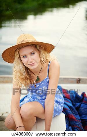 Portrait of young woman with long blond hair in river boat View Large Photo Image Stock Photo - Portrait of young woman with long blond hair in river boat. Fotosearch