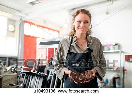 Portrait of young woman with wooden letterpress in print workshop View Large Photo Image Stock Photograph - Portrait of young woman with wooden letterpress in print workshop. Fotosearch