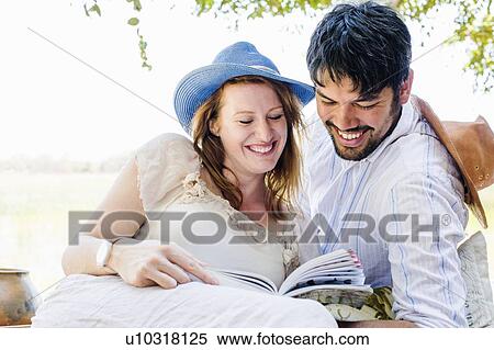 Romantic couple reading guidebook at safari lodge, Kafue National Park, Zambia View Large Photo Image Stock Photography - Romantic couple reading guidebook at safari lodge, Kafue National Park, Zambia. Fotosearch