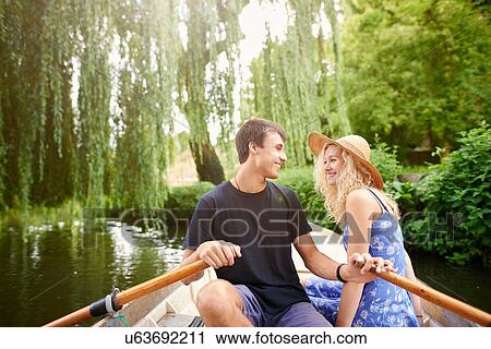 Romantic young couple in rowing boat on rural river View Large Photo Image Stock Image - Romantic young couple in rowing boat on rural river. Fotosearch
