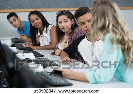 Row of high school students talking in computer class View Large Photo Image Stock Photo - Row of high school students talking in computer class. Fotosearch