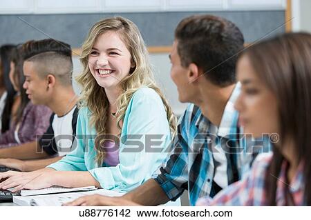 Row of teenage high school students smiling in computer class View Large Photo Image Stock Image - Row of teenage high school students smiling in computer class. Fotosearch