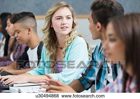 Row of teenage high school students talking in computer class View Large Photo Image Stock Photo - Row of teenage high school students talking in computer class. Fotosearch