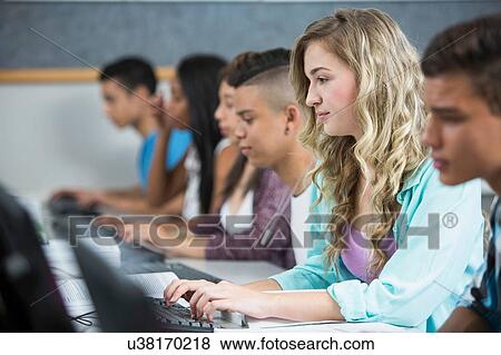 Row of teenage high school students typing on computers View Large Photo Image Stock Photo - Row of teenage high school students typing on computers. Fotosearch
