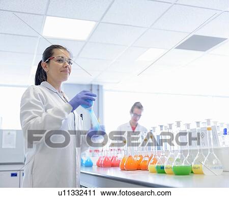 Scientist mixing food colouring in laboratory View Large Photo Image Stock Image - Scientist mixing food colouring in laboratory. Fotosearch