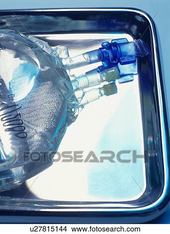 Sealed intravenous drip bag on a surgical tray View Large Photo Image Picture - Sealed intravenous drip bag on a surgical tray. Fotosearch