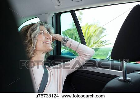 Senior businesswoman looking through car window View Large Photo Image Picture - Senior businesswoman looking through car window. Fotosearch