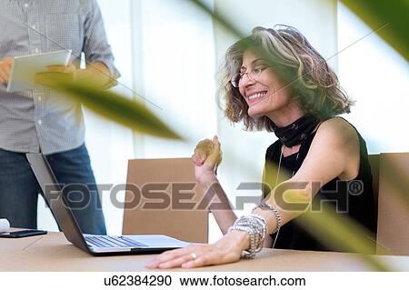 Senior businesswoman using laptop in office View Large Photo Image Stock Image - Senior businesswoman using laptop in office. Fotosearch
