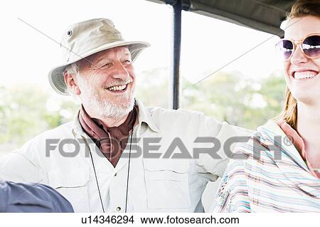 Picture - Senior man and daughter on four wheel drive safari, Kafue National Park, Zambia. Fotosearch
