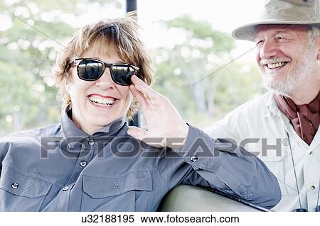 Stock Photography - Senior man and wife on four wheel drive safari, Kafue National Park, Zambia. Fotosearch
