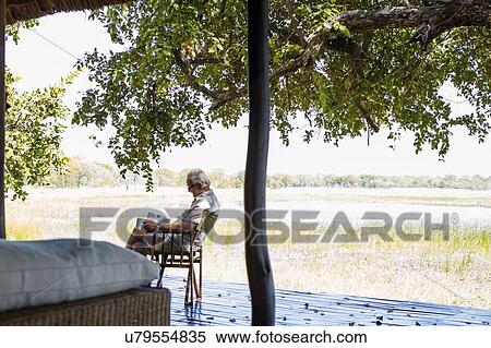 Senior man relaxing at safari lodge, Kafue National Park, Zambia View Large Photo Image Stock Photography - Senior man relaxing at safari lodge, Kafue National Park, Zambia. Fotosearch