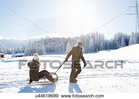 Side view of senior man pulled senior woman on sledge, Sattelbergalm, Tyrol, Austria View Large Photo Image Stock Photo - Side view of senior man pulled senior woman on sledge, Sattelbergalm, Tyrol, Austria. Fotosearch