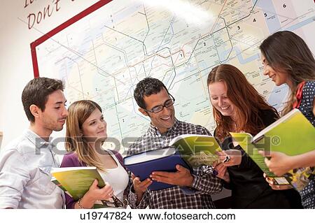 Small group of people, looking through study books View Large Photo Image Picture - Small group of people, looking through study books. Fotosearch