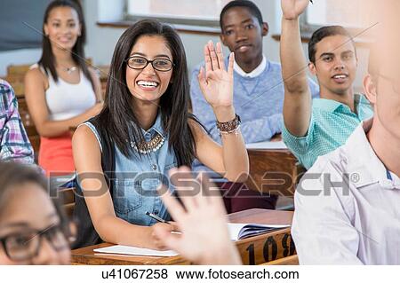 Students in classroom, hands raised View Large Photo Image Stock Photo - Students in classroom, hands raised. Fotosearch