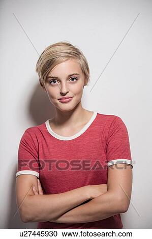 Studio portrait of young woman with short blond hair with arms folded View Large Photo Image Stock Image - Studio portrait of young woman with short blond hair with arms folded. Fotosearch