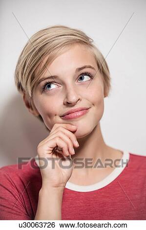 Studio portrait of young woman with short blond hair looking sideways View Large Photo Image Stock Photograph - Studio portrait of young woman with short blond hair looking sideways. Fotosearch