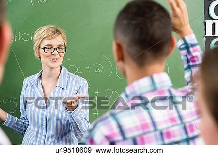 Teacher addressing male student View Large Photo Image Stock Photo - Teacher addressing male student. Fotosearch