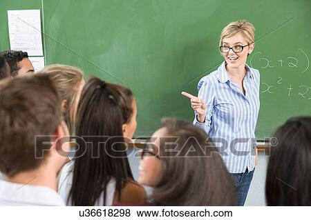 Stock Photo - Teacher addressing students in classroom. Fotosearch