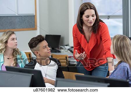 Teacher explaining to high school students in class View Large Photo Image Stock Image - Teacher explaining to high school students in class. Fotosearch