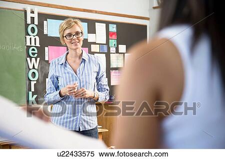 Teacher listening to female student's presentation View Large Photo Image Stock Photography - Teacher listening to female student's presentation. Fotosearch