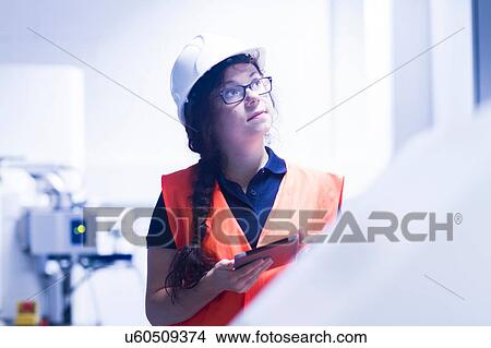 Picture - Technician working in factory. Fotosearch