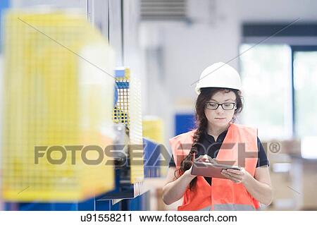 Technician working in factory View Large Photo Image Stock Image - Technician working in factory. Fotosearch