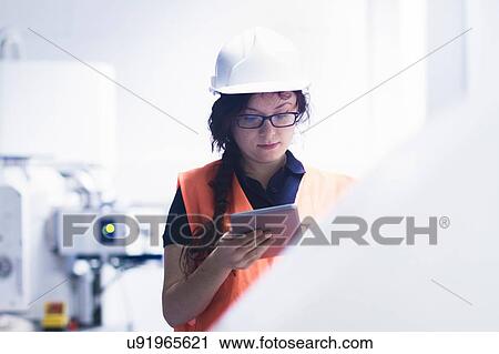 Technician working in factory View Large Photo Image Stock Image - Technician working in factory. Fotosearch