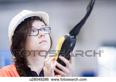 Technician working in factory View Large Photo Image Stock Photograph - Technician working in factory. Fotosearch