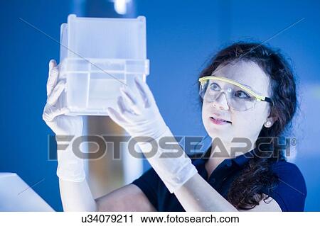 Stock Image - Technician working in laboratory. Fotosearch