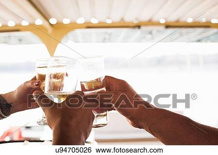 Three male and female hands making a toast with white wine View Large Photo Image Stock Photograph - Three male and female hands making a toast with white wine. Fotosearch