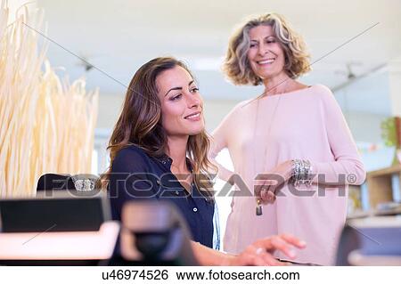 Stock Photograph - Two businesswomen at work in office. Fotosearch