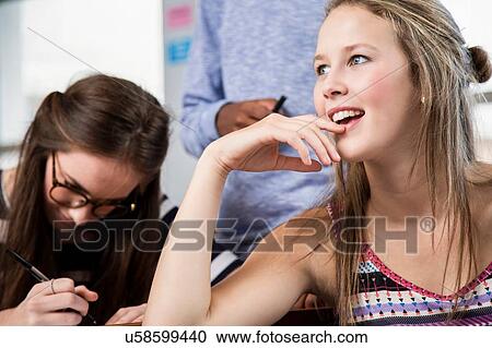 Stock Image - Two female students in classroom. Fotosearch