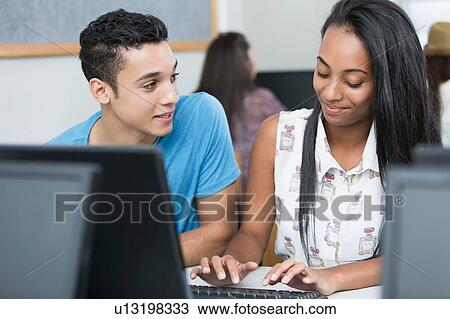 Two teenagers typing on computer in high school class View Large Photo Image Stock Image - Two teenagers typing on computer in high school class. Fotosearch