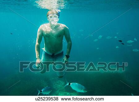 Underwater view of mature man sea snorkeling, Menorca, Balearic islands, Spain View Large Photo Image Stock Photo - Underwater view of mature man sea snorkeling, Menorca, Balearic islands, Spain. Fotosearch