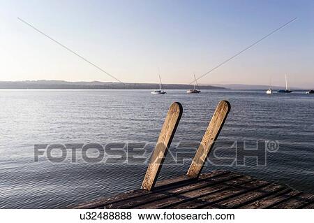 Stock Photo - View of lake from wooden pier, Schondorf, Ammersee, Bavaria, Germany. Fotosearch