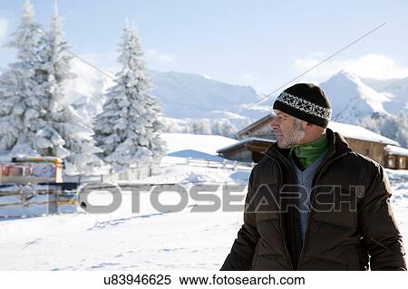 Waist up of senior man and snow covered trees looking away, Sattelbergalm, Tyrol, Austria View Large Photo Image Stock Photography - Waist up of senior man and snow covered trees looking away, Sattelbergalm, Tyrol, Austria. Fotosearch