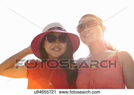 Woman and daughter wearing sunglasses in sunlight View Large Photo Image Stock Image - Woman and daughter wearing sunglasses in sunlight. Fotosearch