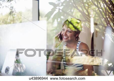 Woman chatting on smartphone in bedroom View Large Photo Image Picture - Woman chatting on smartphone in bedroom. Fotosearch