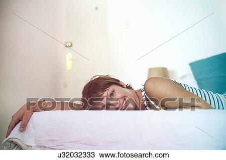 Woman daydreaming in bed View Large Photo Image Stock Image - Woman daydreaming in bed. Fotosearch
