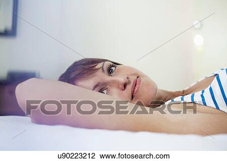 Woman daydreaming in bed View Large Photo Image Stock Image - Woman daydreaming in bed. Fotosearch
